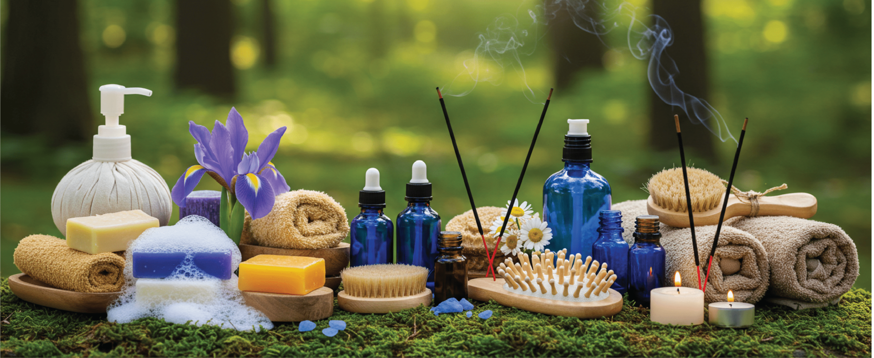 Spa setting with essential oils, candles, incense, and towels