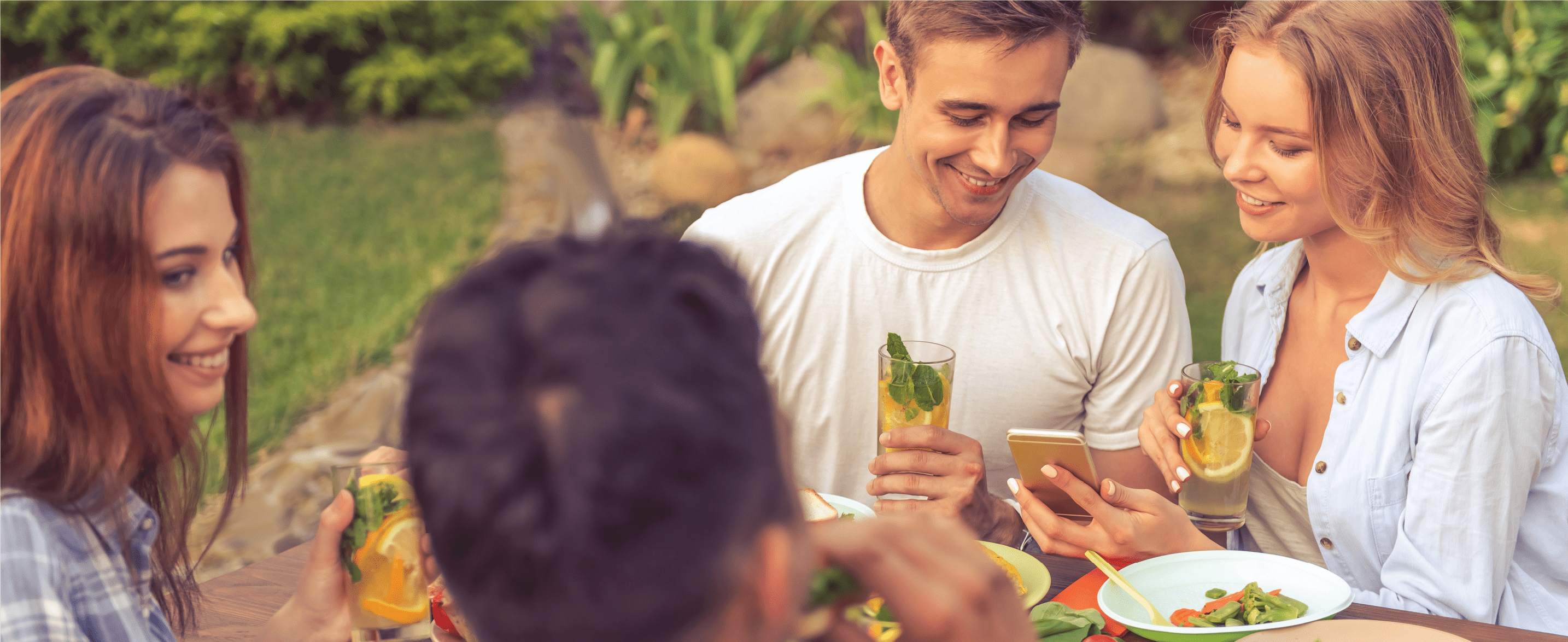 Friends enjoying food and drinks outdoors